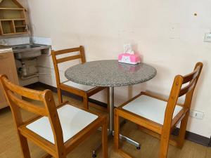 a table with two chairs and a pink cake on it at Impact Arena C4 by Jintana in Ban Bang Phang