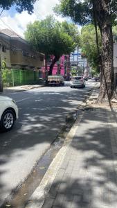 a street with cars parked on the side of the road at Izabelly Andrade in Recife