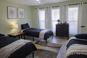 a bedroom with two beds and a window at Fresh Crash Pads 4-Affordable Shared Housing in Houston