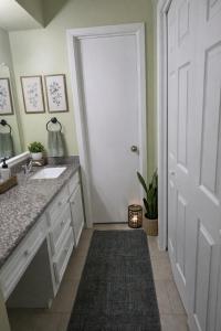a bathroom with a sink and a white door at Fresh Crash Pads 4-Affordable Shared Housing in Houston +13 photos
