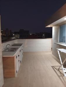 a kitchen with a sink and a counter top at T&S Guest House in Praia