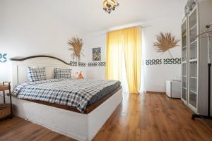 a bedroom with a large bed with a checkered blanket at LaWanda9 in Vama Veche