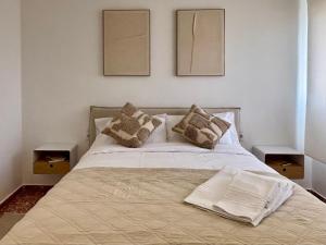 a bedroom with a bed with two pictures on the wall at Cosy Flat Catarroja in Catarroja