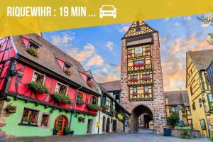a picture of a building with a clock tower at Duplex de Charme - Turckheim - Route des Vins in Turckheim