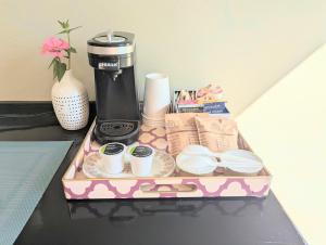 a tray with a coffee maker and cups on a table at Early Birds in Tucson