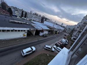 a city street with cars parked in a parking lot at Angely Studio-balcon & parcare gratuită ,Self Check-in in Onești