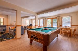 a living room with a pool table in it at Climate Change - Duck, Sea Tern, Oceanside, 280 Yds to Beach, Pool, Hot Tub, Pets OK in Duck