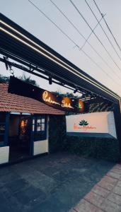 a restaurant with a sign on the front of it at Patnem Garden Resort in Patnem
