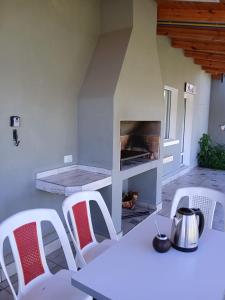 a white table and chairs with a fire place at Cielo in Tafí del Valle +11 photos