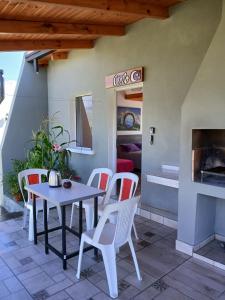 a table and chairs on a patio with a fireplace at Cielo in Tafí del Valle