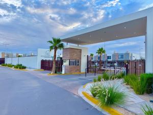 a gas station with palm trees and a building at Casa Marsella 2 Privada y Moderna in Zaragoza