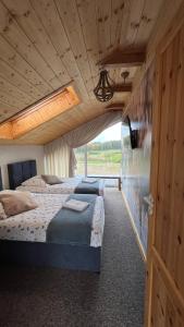 a bedroom with two beds and a wooden ceiling at Czaple Resort in Stare Czaple +212 photos
