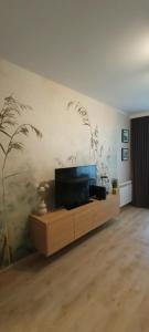 a living room with a flat screen tv on a wall at APARTAMENT RELAX in Ełk