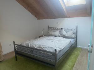 a bed with white sheets and pillows in a room at Bordinghouse Arndt in Memmingen