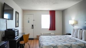 a hotel room with a bed and a television at Motel 6-Rolla, MO in Rolla