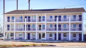 a large white building with balconies on a street at Motel 6-Rolla, MO in Rolla