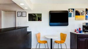 a bar with two chairs and a tv on a wall at Motel 6-Rolla, MO in Rolla