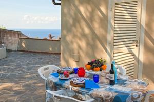 a table with a blue table cloth on a patio at Villa Ginanneschi - Le Pitte in Capoliveri