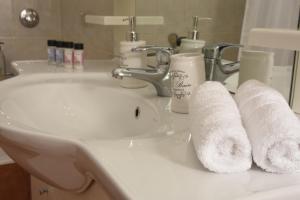 a bathroom sink with two rolls of paper towels on it at Sparta Central Apartment with Free Parking in Sparta +27 photos