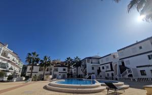 a swimming pool in the middle of a building at Caballito del Mar apartment in Punta Prima