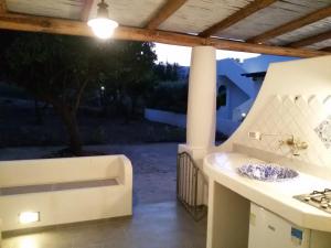 a outdoor kitchen with a sink and a stove at Labottega home in Lipari +13 photos