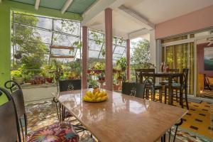 a dining room with a table with bananas on it at Villa Les Violettes in Morne-à-lʼEau