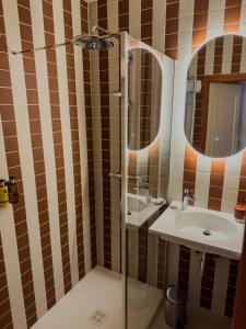 a bathroom with a shower and a sink and a mirror at Relais Manderen in Manderen +37 photos