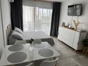 a bedroom with a bed and a table and a tv at Departamento temporal in Morón