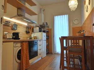 a kitchen with a stove and a dishwasher at La casetta di Elena - Sondrio Valtellina in Sondrio