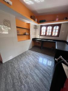 an empty room with a table and a window at HostelVK Gokarna in Gokarna +16 photos