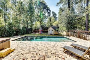 a swimming pool in a backyard with a playground at 6BD55B,BrookhavenSleeps 12,Big yard,w poolGate in Atlanta
