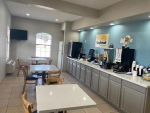 a restaurant with a counter and tables and chairs at Days Inn by Wyndham Centerville in Centerville