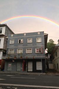 a rainbow in the sky above a building at Pousada Jardim Alameda in Blumenau