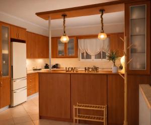 a kitchen with wooden cabinets and a white refrigerator at Konitsa Horizon Villa in Konitsa +15 photos
