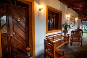 a room with a door and a table and chairs at A Flor Pousada in Garanhuns