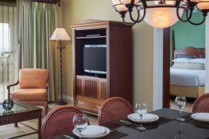 a living room with a dining table and a television at Hyatt Vacation Club at Windward Pointe in Key West +35 photos