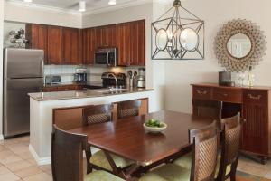 a kitchen with a wooden table and a dining room at Hyatt Vacation Club at Windward Pointe in Key West