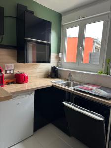a kitchen with a counter top with a sink at La Petite Maison in Brest