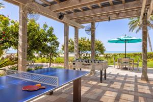 a blue ping pong table on a patio with an umbrella at Hyatt Vacation Club at Windward Pointe in Key West