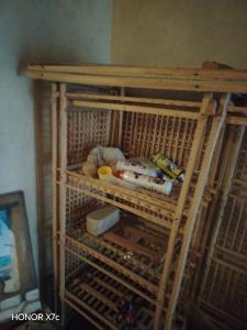 a wooden cage with some items on it at Siwa Shaly in Siwa