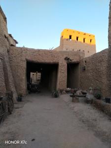 a large brick building with a tunnel in it at Siwa Shaly in Siwa
