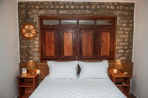 a bedroom with a bed with two nightstands and two lamps at A Flor Pousada in Garanhuns