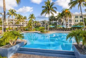 a swimming pool with palm trees and condos at Hyatt Vacation Club at Windward Pointe in Key West