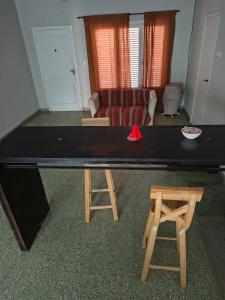 a ping pong table and two stools in a living room at Lisboa in Chacabuco