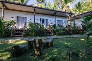 a house with a tree stump in front of it at Somewhere In Bocas in Bocas Town