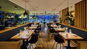 a restaurant with wooden tables and chairs and a bar at Buchners Hotel & Restaurant in Niederwinkling