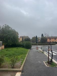 an empty parking lot with a road and grass at Granaretto 27 in Palidoro