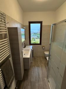 a bathroom with a sink and a toilet and a window at Casa Rosetta in Tignale +5 photos