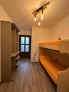 a room with two bunk beds and a hallway at Casa Rosetta in Tignale