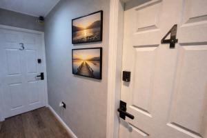 a hallway with a door with three pictures on the wall at 2nd DANESGATE in Lincoln